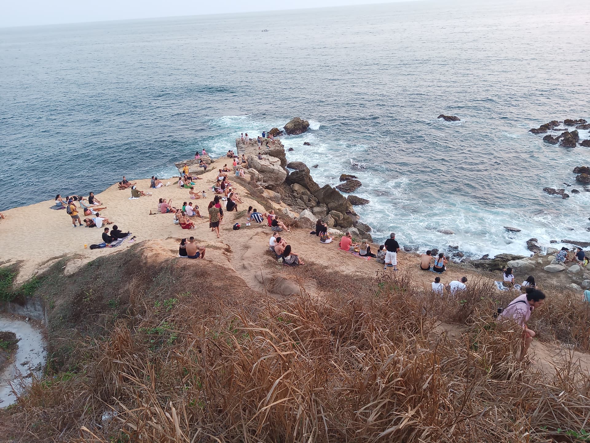 Crowds gathered on the rocky point at Puerto Escondido for the evening sunset